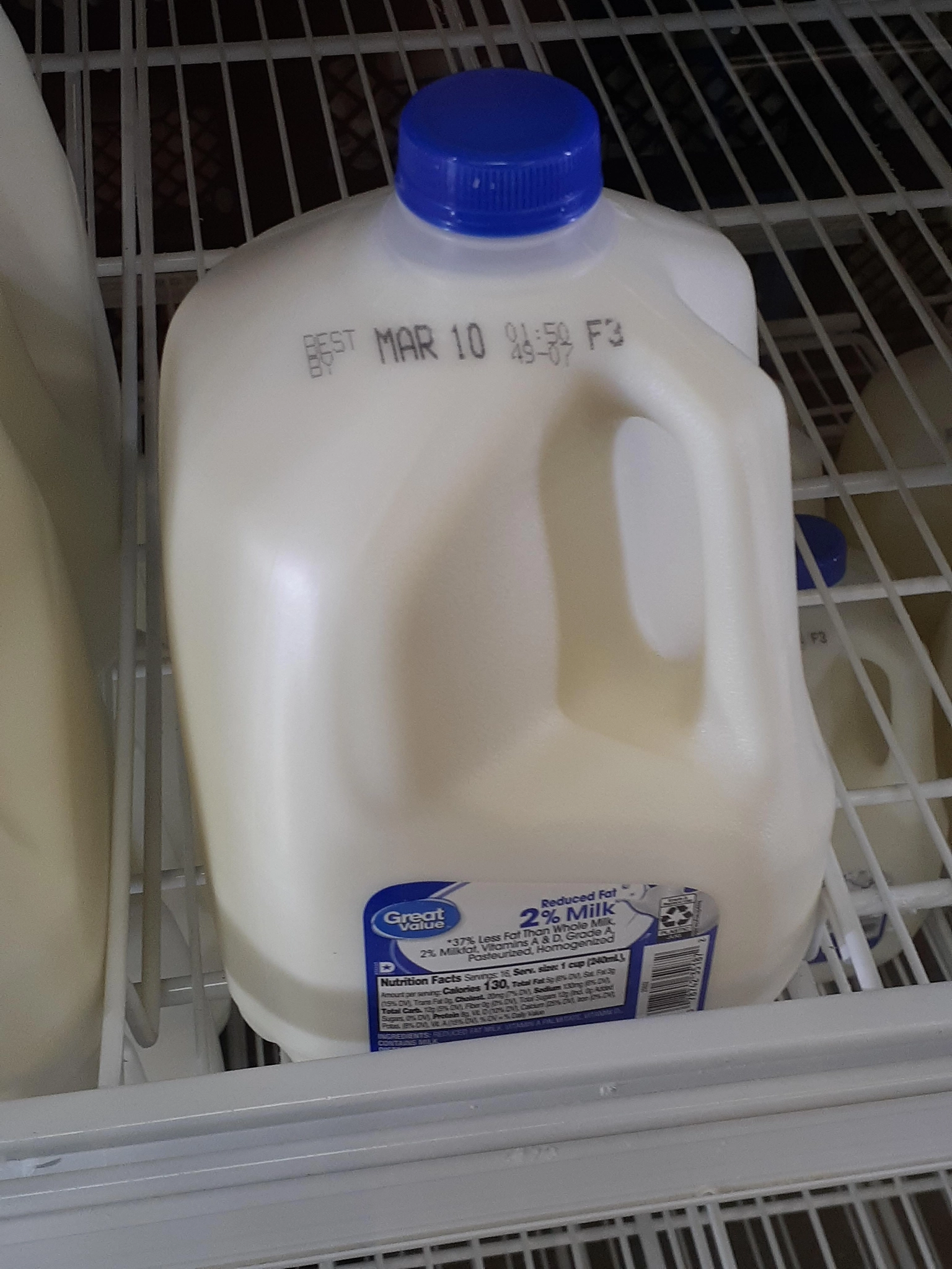 image of a milk jug with the best by date being "MAR10" on a store shelf